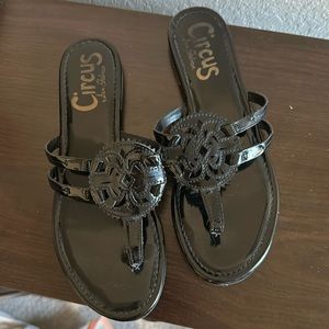 Women’s patent black sandals.